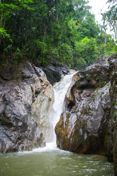 Mountain river with a waterfall. Flowing mountain river natural landscape.