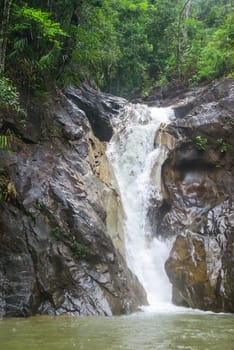 Mountain river with a waterfall. Flowing mountain river natural landscape.