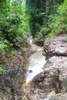 Mountain river with a waterfall. Flowing mountain river natural landscape.