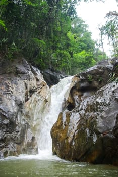 Mountain river with a waterfall. Flowing mountain river natural landscape.