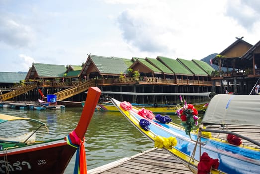 Phuket, Thailand - July 23, 2014: Fishing village on the bay in Thailand. Fishermen's houses and moorings.