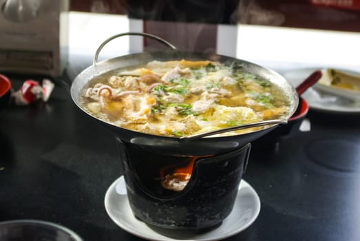 Seafood soup. Octopus in soup in the dining room.