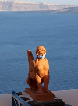 Covid timestamp on the mythological Sphinx in Oia, Santorini. Greece