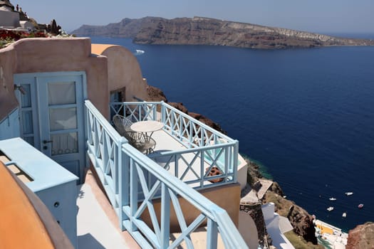 Oia  Santorini  Greece - July 3  2021: Whitewashed houses with terraces and a beautiful view in Oia on Santorini island, Greece