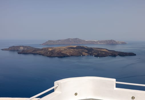 View from Santorini to volcanic island Nea Kamena, Cyclades, Greece