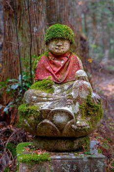 statue with commemorative stone hat inside the Okunoin Koyasan cemetery