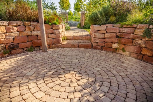 Sunny garden patio with sitting area and herbal garden