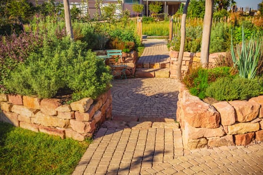 Sunny garden patio with sitting area and herbal garden