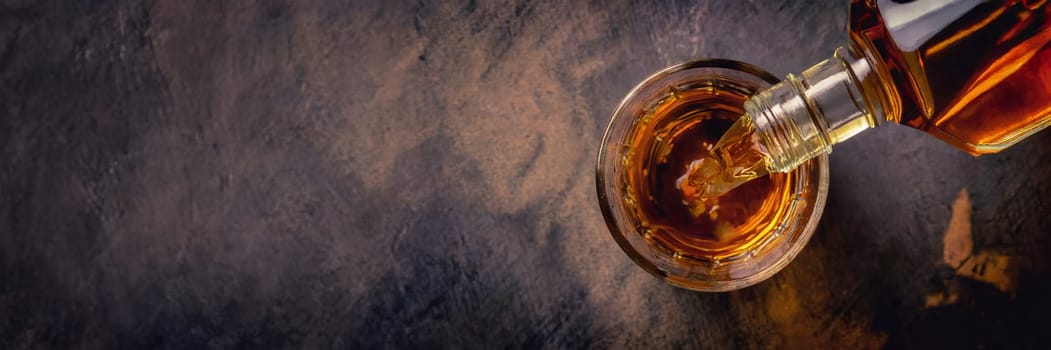 Pouring whiskey from bottle into glass on bar counter. AI generated