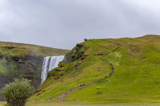 Skogar Iceland - July 28, 2023: Tourists visiting Skogafoss waterfall in south Iceland