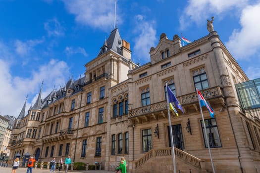 Luxembourg - 01 August 2023: Tourists walking in front of Palais Grand-Ducal official residence of the Grand Duke of Luxembourg