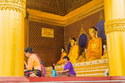 Yangon, Myanmar: 17 August 2020: Worshippers visit Shwedagon Pgoda. Shwedagon Pagoda is the most sacred Buddhist pagoda in Myanmar.