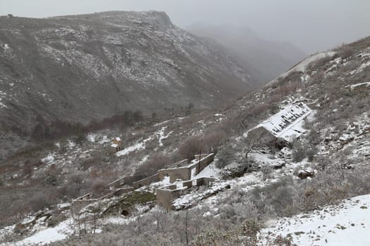Old houses in ruins in the mountains, lots of snow in the north of Portugal