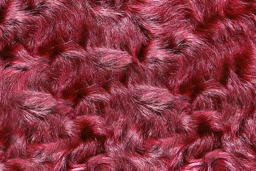 The faux fur with long hair is colored burgundy.Texture or background