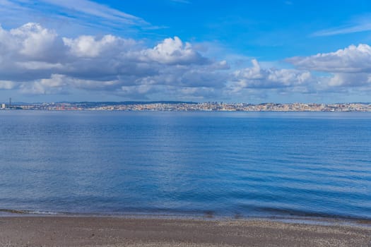 Lisbon on the Tagus river bank, central Portugal. View from Seixal. Tagus is the largest river of the Iberian Peninsula
