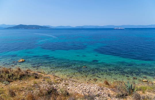 The coast of Aegina island with clear and blue waters of Mediterranean sea in the Saronic gulf, Greece.
