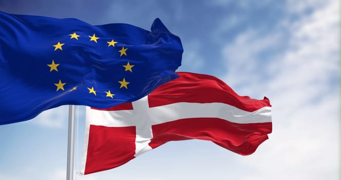 The national flag of Denmark and the flag of the European Union flutter in the wind against a serene sky backdrop. 3D rendered illustration. Flutering fabric. EU membership