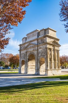 Orange, France - November 29 2023: Roman triumphal arch, historical memorial building in Orange city, in the Provence-Alpes-Côte d'Azur region. Vertical photography taken in France