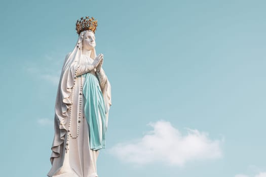 Lourdes, France - August 28, 2021: Sculpture of the crowned Virgin Mary in the Sanctuary of Lourdes, France. Place of worship and pilgrimage for christians