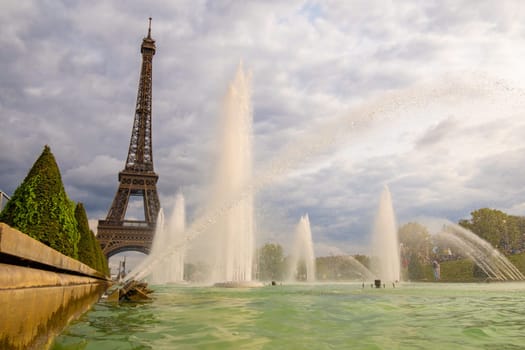 Paris, France - August 29 2023: Eiffel tower seen from Trocadero Fountains in a cloudy day. Photography taken in Paris.