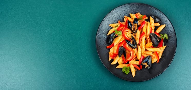 Macaroni or pasta vongole with mussels in the shell, clams on a stylish dark plate. Flat lay with copy space. Space for text