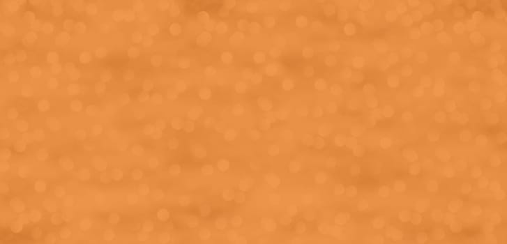 A glittering background with dots of light in Peach Fuzz