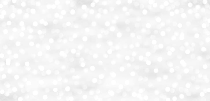 A glittering white background with dots of light