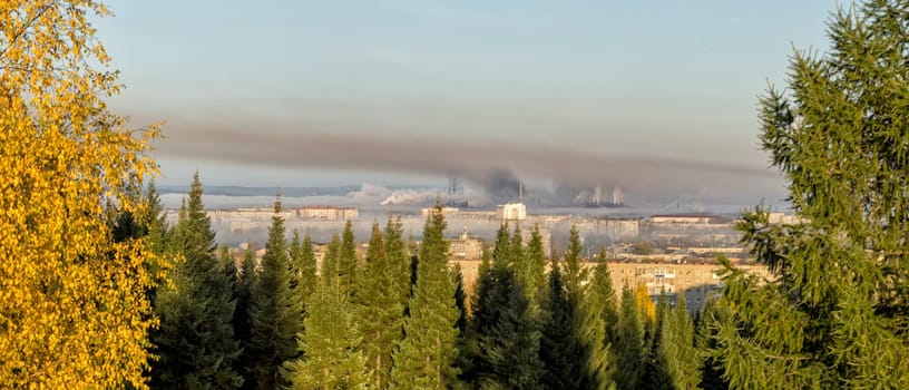 Landscape of smoking chimneys of factories in an industrial city. Dangerous ecology in the industrial city. Smoke and smog from factories and plants.