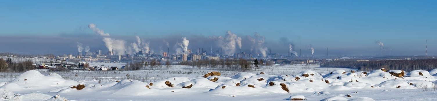 Landscape of smoking chimneys of factories in an industrial city. Dangerous ecology in the industrial city. Smoke and smog from factories and plants.
