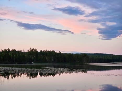Sunset on a lake in Sweden. Blue hour on calm water. Nature photo from Scandinavia. Landscape shot