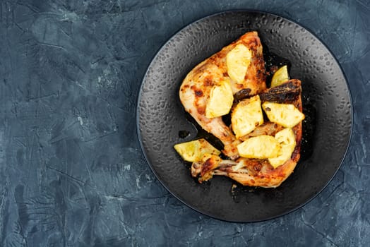 Chicken legs fried with pineapple pieces. Grilled chicken meat. Copy space.