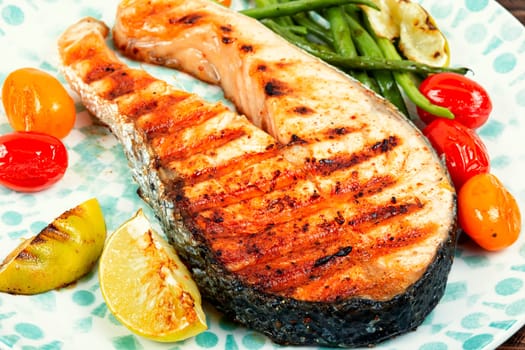 Fried salmon steak and vegetable salad. Grilled fish, keto diet, healthy food.