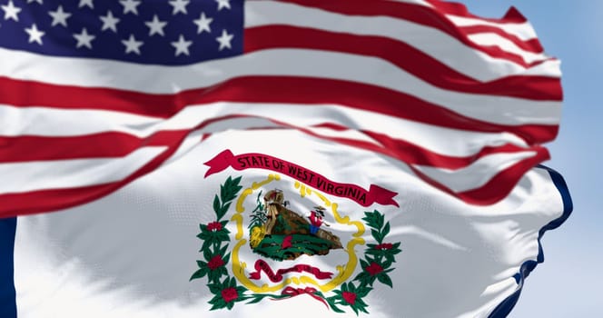 Close-up of West Virginia state flag waving in the wind with the american flag on a clear day. 3d illustration render. Fluttering fabric. Selective focus