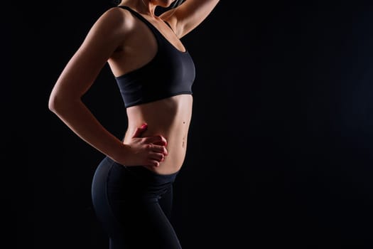 Happy fit woman on studio background. Smiling female fitness workout. Healthy lifestyle concept.