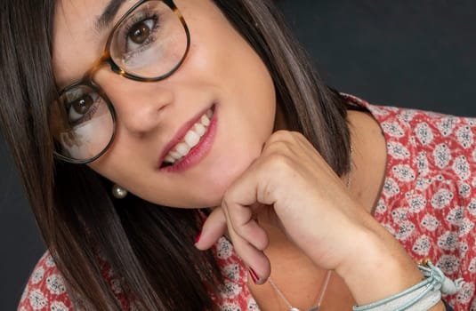 portrait of a charming young brunette woman with glasses