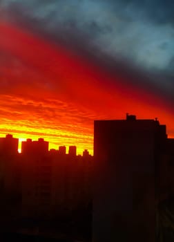 Colorful suburban sunset over residential buildings close-up
