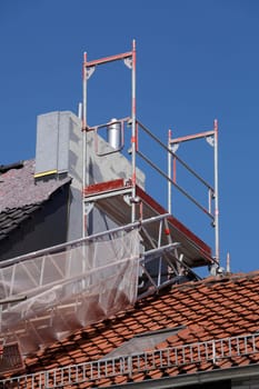 Scaffolding with chimney and roof on an old building, Bremen, Germany
