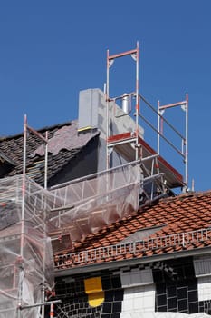 Scaffolding with chimney and roof on an old building, Bremen, Germany