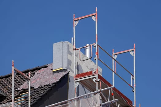 Scaffolding with chimney and roof on an old building, Bremen, Germany