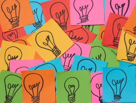 Drawn electric lamps on pieces of paper, the concept of searching for new solutions and ideas