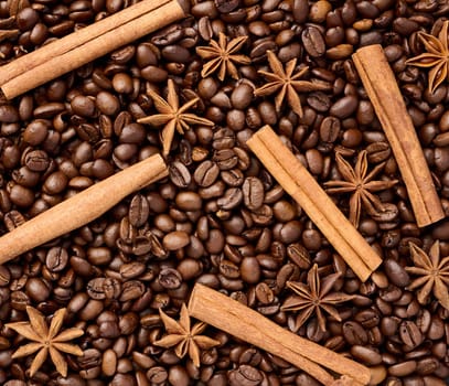 Roasted coffee beans, cinnamon sticks and star anise, full frame