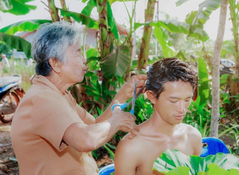 Nakhonsithammarat, Thailand- April. 08, 2016: Ordained, Elders and people join together to shave the head of a young man who is about to be ordained, According to the principles of belief in Buddhism