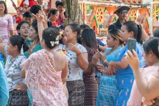 SURATTANI, THAILAND- NOV. 06, 2023: Burmese people dress in national costumes. Come out to participate and dance in the Kathin festival during the end of Buddhist Lent for Burmese brothers and sisters in Thailand.