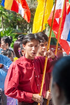 SURATTANI, THAILAND- NOV. 06, 2023: Burmese people dress in national costumes. Come out to participate in the Kathin festival during the end of Buddhist Lent for Burmese brothers and sisters in Thailand.