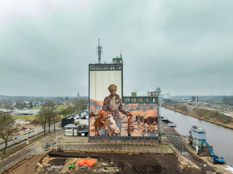 LOCHEM, NETHERLANDS - JANUARY 20, 2024: Artwork on a large building as part of the Achterhoek  Silo Art Tour, whereby barns, silos and other agricultural buildings have been transformed into works of art.