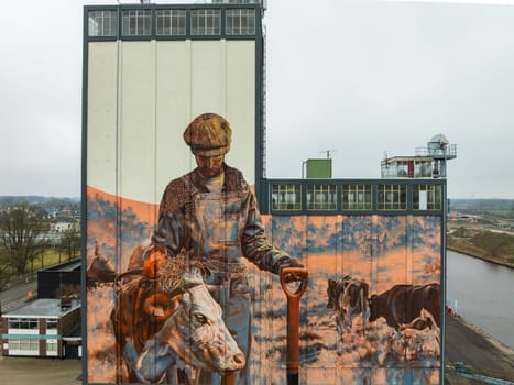 LOCHEM, NETHERLANDS - JANUARY 20, 2024: Artwork on a large building as part of the Achterhoek  Silo Art Tour, whereby barns, silos and other agricultural buildings have been transformed into works of art.