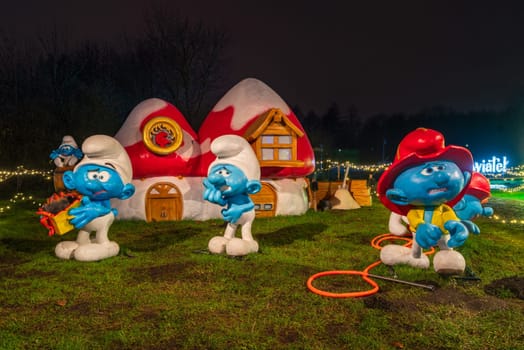 KRAKOW, POLAND - DECEMBER 25, 2023: Smurfs exhibition in the Garden of Light during Christmas time