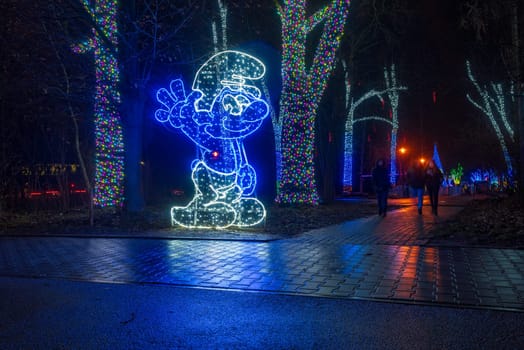 KRAKOW, POLAND - DECEMBER 25, 2023: Smurfs exhibition in the Garden of Light during Christmas time