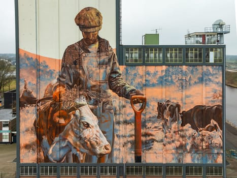 LOCHEM, NETHERLANDS - JANUARY 20, 2024: Artwork on a large building as part of the Achterhoek  Silo Art Tour, whereby barns, silos and other agricultural buildings have been transformed into works of art.