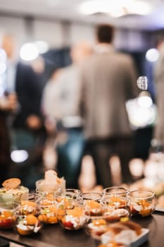 Blurred image of businesspeople at banquet event business meeting event. Business and entrepreneurship events concept. Focused on the canapes.